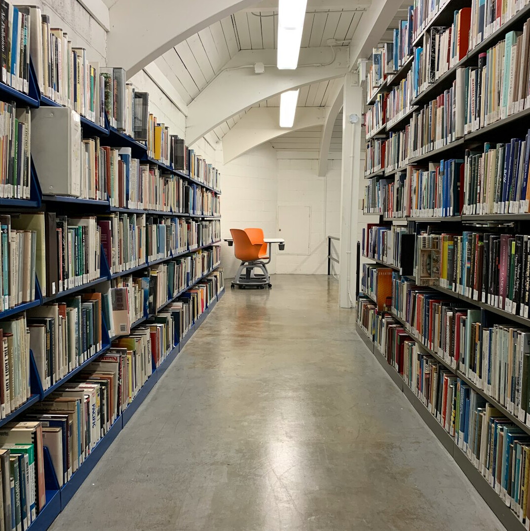 Quiet library with tall shelves of books