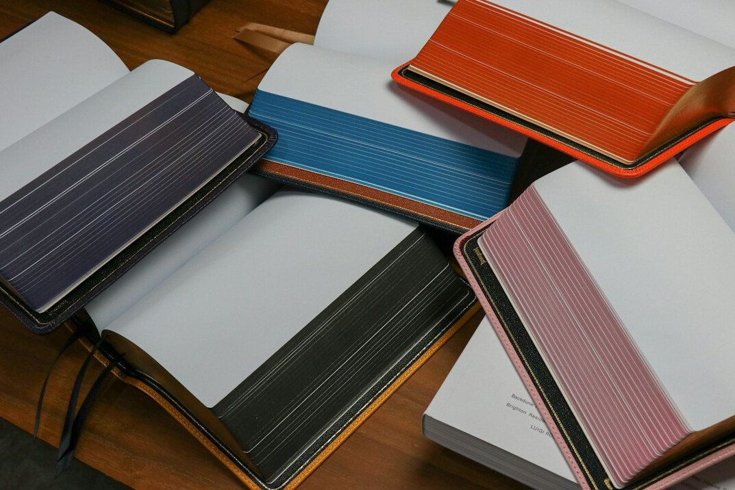 Notebooks and pens on a wooden desk
